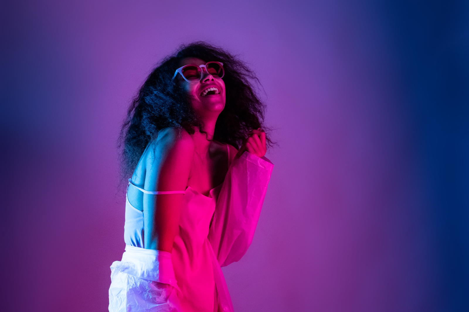 Placeholder campaign portrait of a contemporary African shopper in purple and magenta lighting